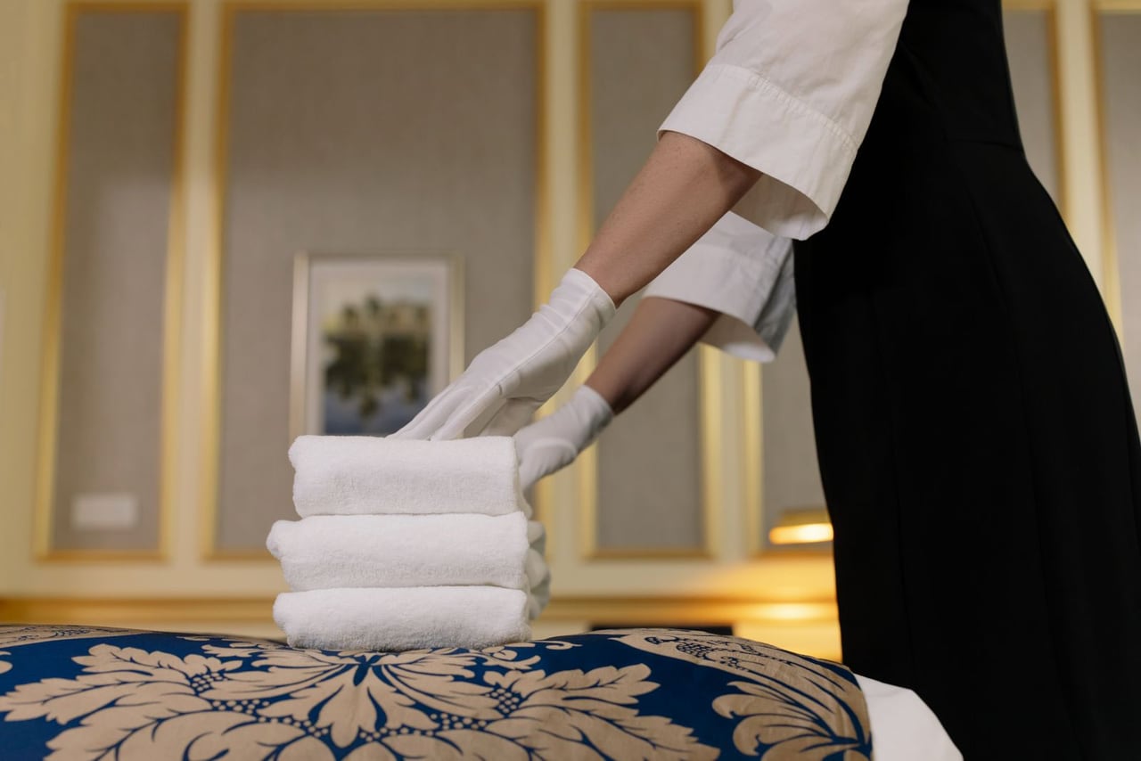 Housekeeper carrying folded towels